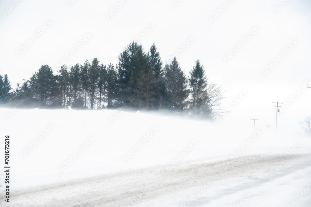 Snow blowing during a wintry storm