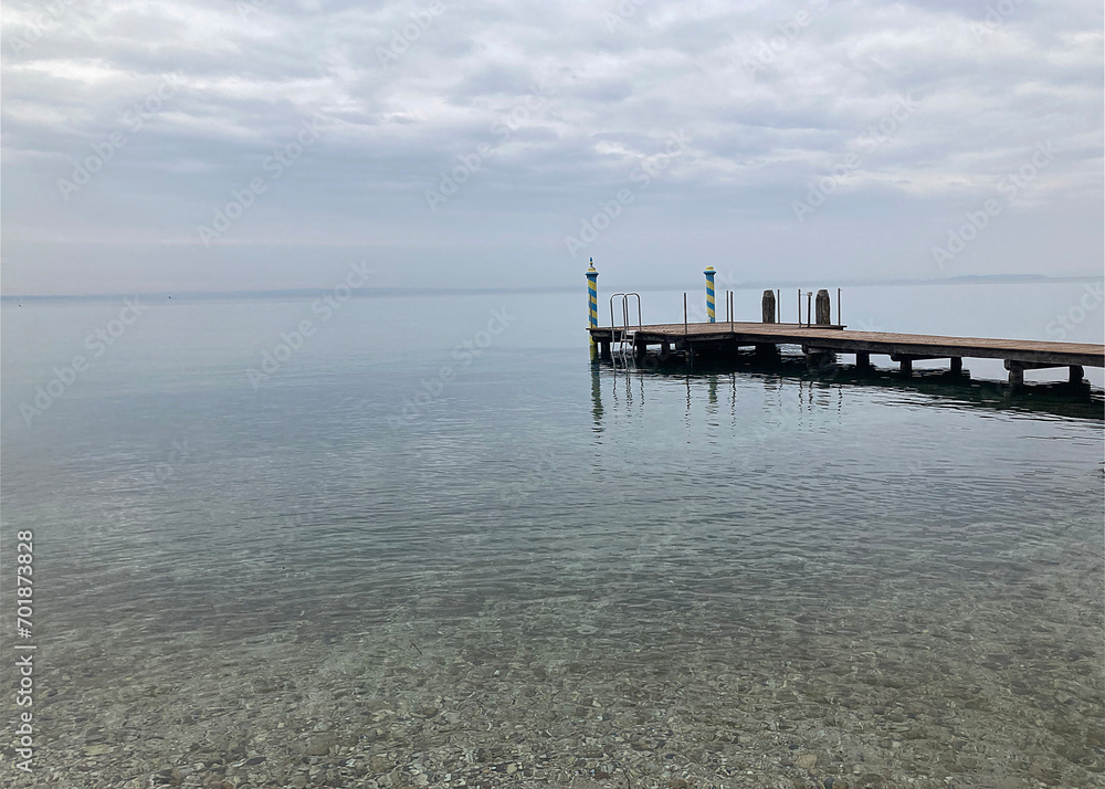 Wooden pier in the sea on a background of cloudy sky
