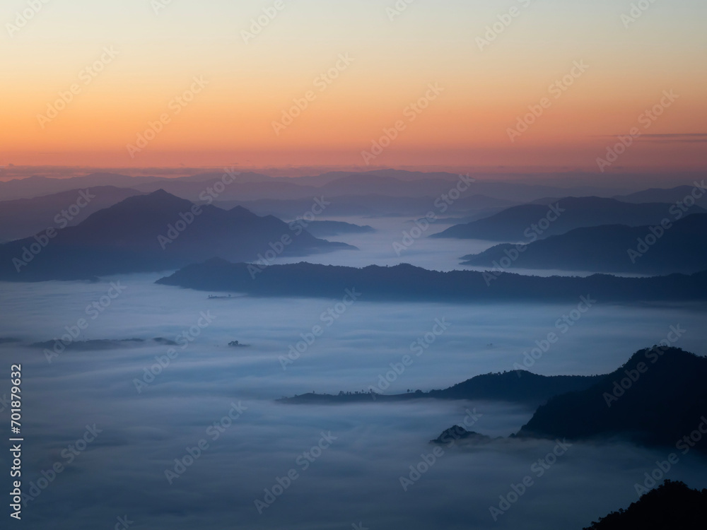 Scenic view of sea of clouds around mountain peaks at sunrise at Phu Chi Fa in Chiang Rai,Thailand. Scenic view of sea of clouds around mountain peaks at sunrise at Phu Chi Fa in Chiang Rai,Thailand.