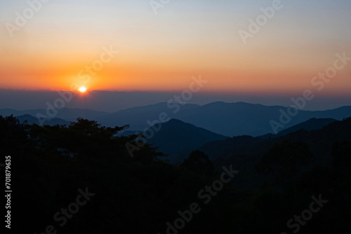 Scenic view at sunset time with silhouette mountain view at Phu Chi Fa Forest Park in Chiang Rai, Thailand. © Runglawan