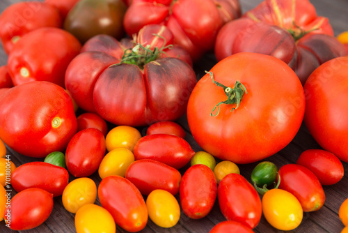 Different varieties of ripe red and yellow appetizing tomatoes