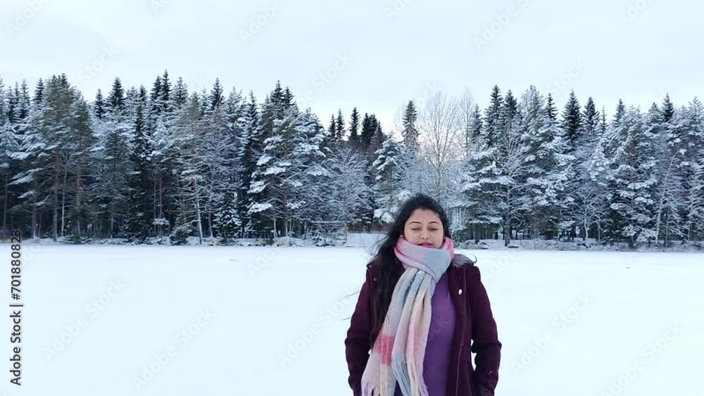 A woman enjoying and taking pictures of snow landscape. Cheerful girl enjoying beautiful winter day. Carefree lady having joyful emotions outdoor. Winter concept. Slow motion A woman enjoying and taking pictures of snow landscape. Cheerful girl enjoying beautiful winter day. Carefree lady having joyful emotions outdoor. Winter concept. Slow motion