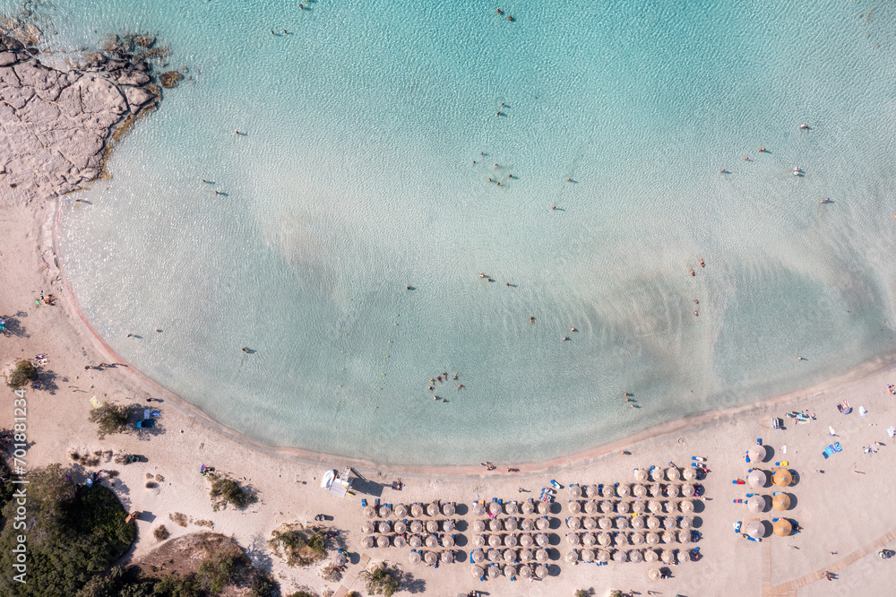 Elafonisi beach with pink sand, umbrella, Crete Greece. Aerial drone view of famous summer resort.