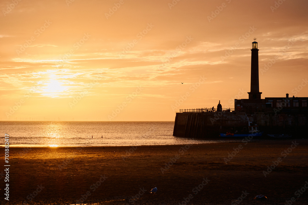 sunset on the beach with lighthouse
