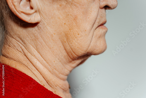 the flabby skin of an old grandmother. the woman has an old neck. wrinkled skin in an elderly person