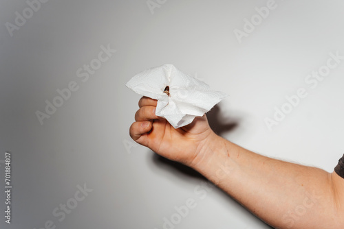 killing a cockroach with a napkin. a man holds a dead cockroach with paper. the killed insect photo