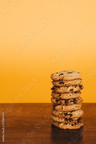 Delicious Breakfast: Cookies and Milk on a Wooden Table with an Orange Background.