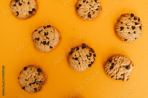 Delicious Breakfast: Cookies and Milk on a Wooden Table with an Orange Background.