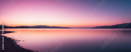  Soft gradients of pink and magenta transition into a tranquil blue, capturing the essence of a serene horizon at dawn or dusk. © simo