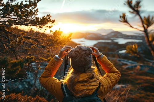 On a journey through the wilderness, a female traveler pauses to frame the sunrise with her hands, a silent affirmation of her freedom and the thrill of adventure.