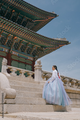 Tourist girl wearing traditional korean hanbok at the Gyeongbokgung Palace in Seoul, South Korea.