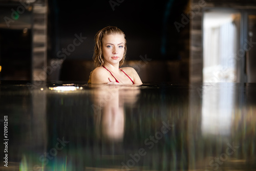 Serene woman relaxing in indoor pool