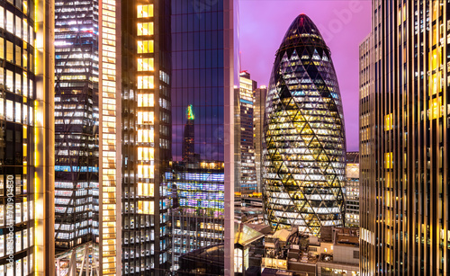 Photography Night time panorama of the skyline of modern City of London with colorful lights, illumination and window glass reflections