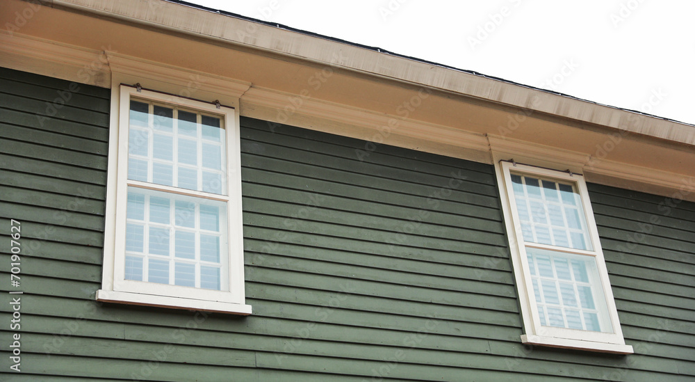 Suburban house, symbolizing mortgage burden amid financial inflation, with worried owners