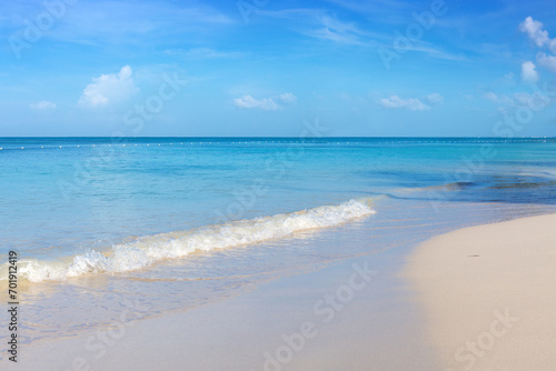 Tropical paradise beach with white sand and blue sky.