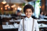 happy indian child boy waiter in restaurant, cafe or bar