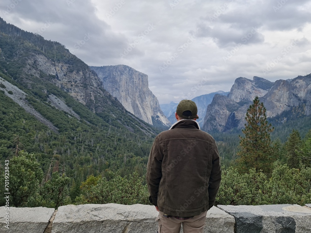 A man looking at the tunnel view, a man looking at a stunning green mountain view