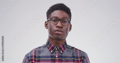 Serious black man, glasses and face of nerd or geek isolated against a studio background. Portrait of smart African person or casual model looking with spectacles, blank stare or eyewear on mockup