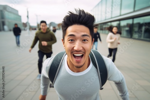 happy asian man running on the background of a crowd of people