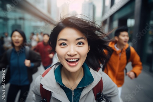 happy asian woman running on the background of a crowd of people