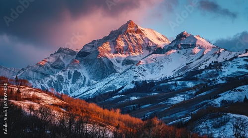 their peaks often adorned with snow or bathed in the warm hues of sunset 