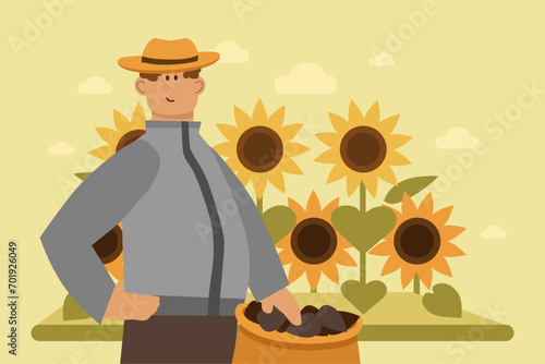 Male farmer gathering sunflower seeds at farm