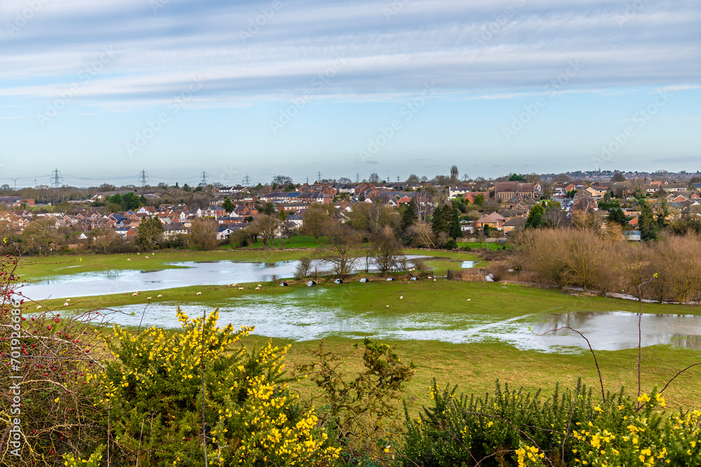 A view towards Huncote from Huncote Nature reserve in Leicestershire, UK on a bright sunny day