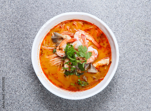 thai rice noodle in tom yum kung soup served in soup isolated on grey background top view of hong kong food photo