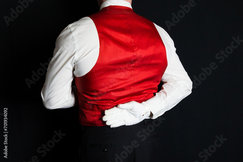 Portrait of Butler or Waiter in Red Vest or Waistcoat and White Gloves Standing At Elegant Attention. Service Industry and Professional Courtesy. © jeremyimagery.com