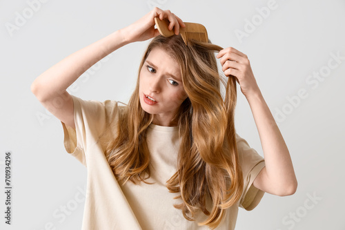 Upset young woman with hair...
