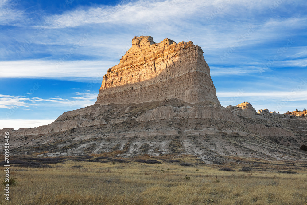 Scotts Bluff National Monument Nebraska landscape in winter at sunset with blue sky and clouds.  