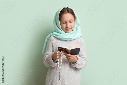 Little Muslim girl with Qur...