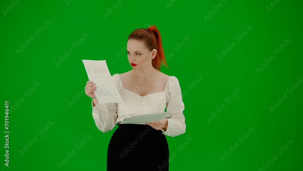 Portrait of attractive office girl on chroma key green screen. Woman in skirt and blouse reading documents Portrait of attractive office girl on chroma key green screen. Woman in skirt and blouse reading documents
