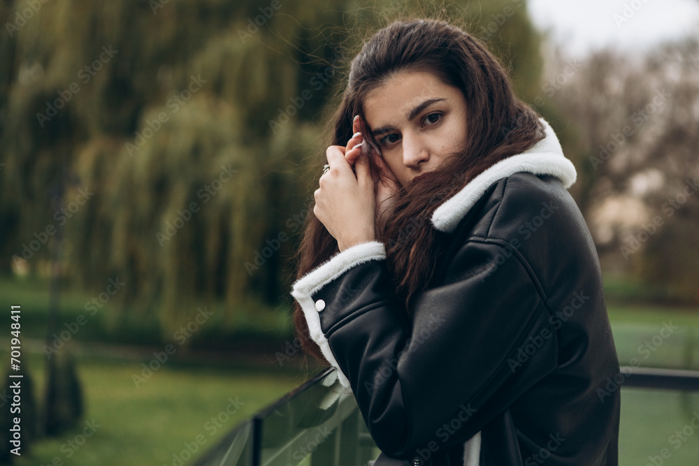 Attractive pretty woman standing outdoor on glass balcony, portrait of young lady dressed leather wool fur jacket, confident, serious, cold weather windy autumn spring
Attractive pretty woman standing outdoor on glass balcony, portrait of young lady dressed leather wool fur jacket, confident, serious, cold weather windy autumn spring