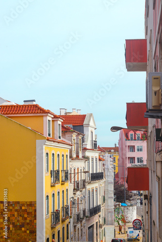 Exterior facades of historical houses with apartments in Lisbon, Portugal. Urban vintage background. Alfama district. The building is tiled with carved balconies.