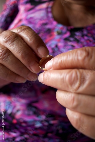 elderly woman puts wedding ring on her finger, romantic, melancholy concept