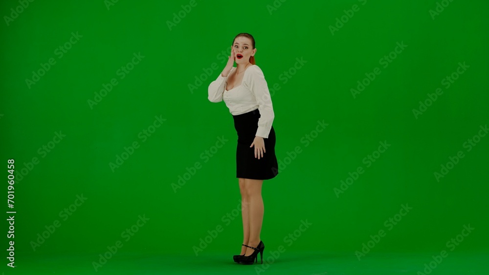 Portrait of attractive office girl on chroma key green screen. Woman in skirt and blouse posing with surprised face expression, winning gesture. Portrait of attractive office girl on chroma key green screen. Woman in skirt and blouse posing with surprised face expression, winning gesture.