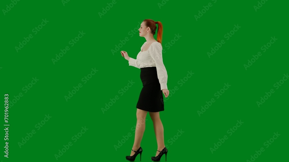 Portrait of attractive office girl on chroma key green screen. Woman in skirt and blouse walking cutely. Side view. Portrait of attractive office girl on chroma key green screen. Woman in skirt and blouse walking cutely. Side view.