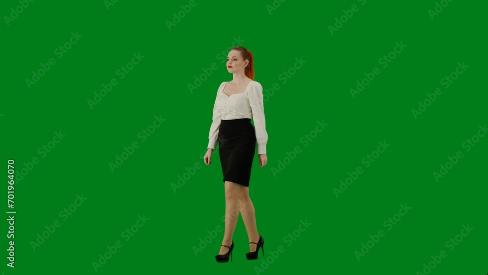 Portrait of attractive office girl on chroma key green screen. Woman in skirt and blouse walking cutely. Side view. Portrait of attractive office girl on chroma key green screen. Woman in skirt and blouse walking cutely. Side view.