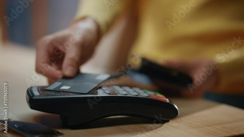 Closeup woman hands paying credit card over terminal at store. Client payment photo