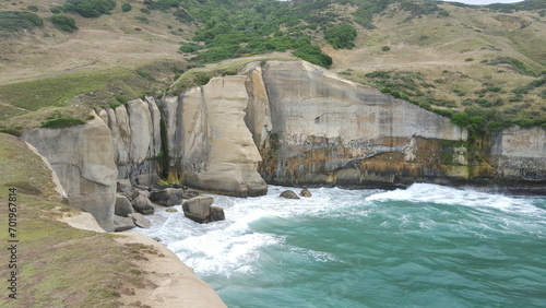 new zealand cliff waves water beach sea turquoise