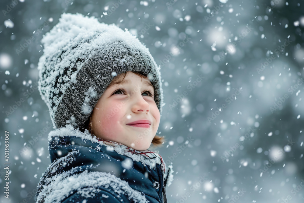 Happy kid wearing warm clothes plays outdoors with snow in winter. Happy kid wearing warm clothes plays outdoors with snow in winter.