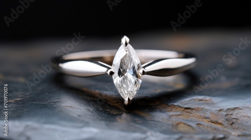 Upclose image of a modern marquise diamond, set in a sleek and minimalistic white gold band. photo