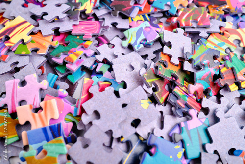 Top view of many puzzle pieces throughout the frame. Background image of scattered colorful puzzle pieces. Mind games
