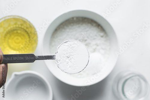 Bild auf Leinwand A spoon of baking soda or baking powder