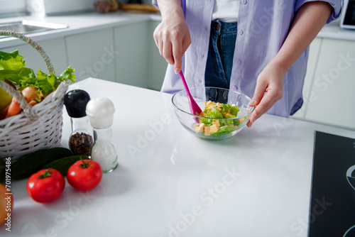 Cropped photo of charming lady dressed purple shirt cooking dinner stirring vegetable salad indoors house kitchen