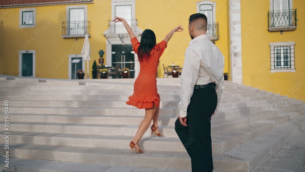 Passionate hispanic couple dancing hot choreography latin style on street stairs Passionate hispanic couple dancing hot choreography latin style on street stairs
