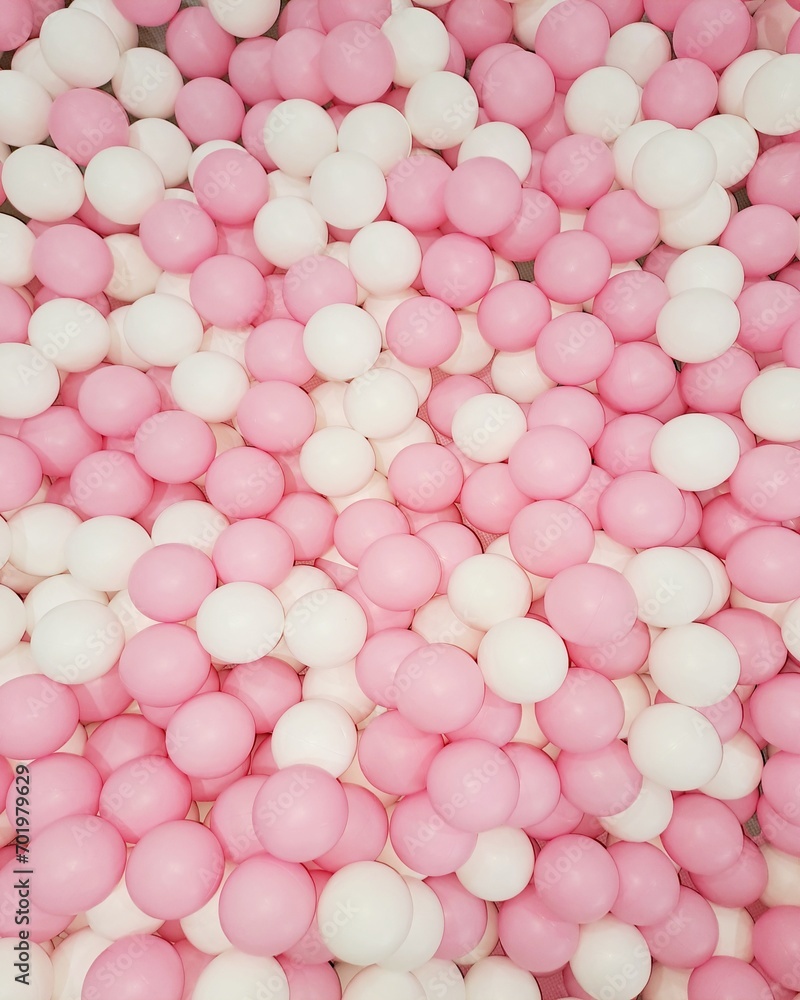 Many plaster balls pink and white dry pool kids activity in kindergarten background Many plaster balls pink and white dry pool kids activity in kindergarten background