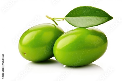 Two green olives with leaves on white background isolated