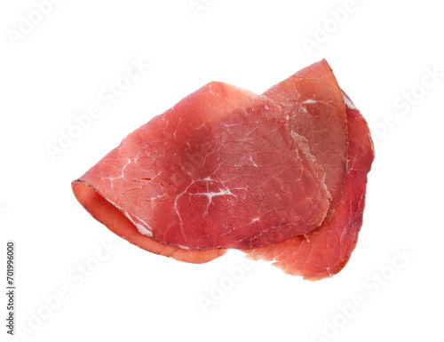 Slices of tasty bresaola isolated on white, top view photo